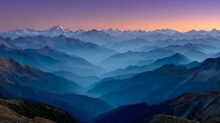 Layered mountain range — bathed in blue haze, stretching into the distance at dusk.