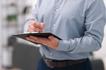 Real estate appraisal. Inspector with clipboard conducting property valuation at home, closeup
