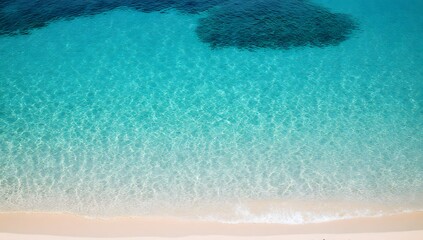 Crystal-clear turquoise water gently lapping at a white-sand beach.