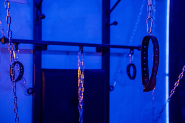 BDSM installation. Wall with chains and handcuffs.