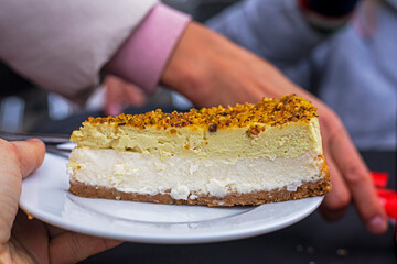 slice of fresh cheesecake topped with nuts