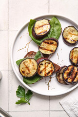 Toasts with delicious grilled eggplants on light background