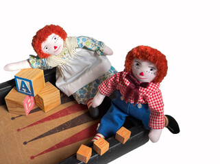 Raggedy Ann & Andy are hand stitched and are displayed with old wood blocks & a backgammon board. Colorful and isolated  playtime design.