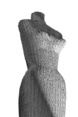 Lacy fuzzy white fabric covers female mannequin in artistic fashion. Sculpted curvy body shows a woman’s bodice.