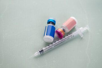 Single Use Syringes Next to Small HRT or Peptide Vials