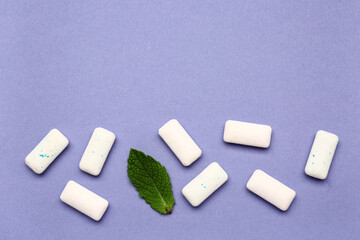 Fresh chewing gums with mint on lilac background
