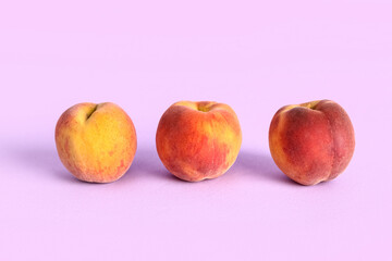 Sweet peaches on lilac background