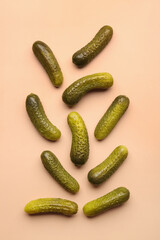 Pickled cucumbers on orange background