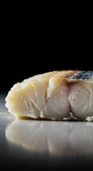 Close-up of a perfectly cooked, flaky white fish portion, highlighting its delicate, tender texture and light, clean appearance ,side dish ,tender ,protein