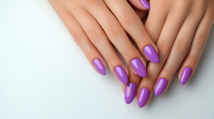 Close-up of manicured hands with purple nails on white background.  Possible use Beauty product advertisement