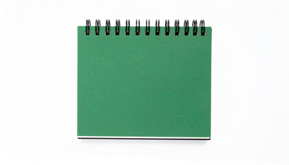 A blank green spiral-bound notebook sits open, ready for notes and ideas