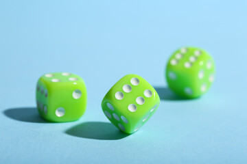 Green game dices on blue background