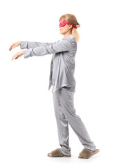 Female sleepwalker in pajamas on white background
