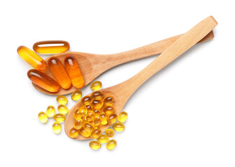 Wooden spoons with vitamin E capsules on white background