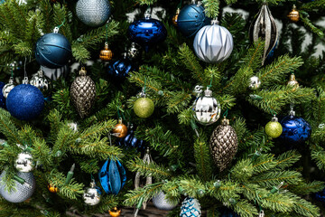 Artificial Christmas tree with silver and blue ornaments