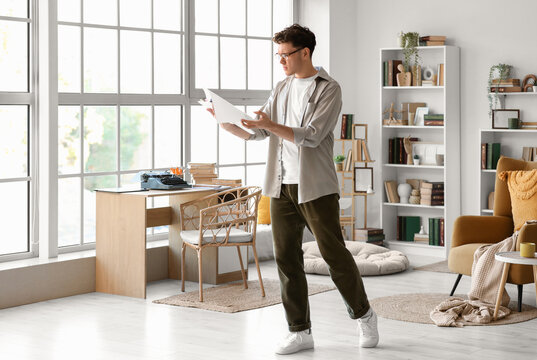 Male screenwriter with script in office