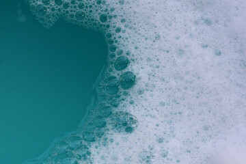 Foamy blue water surface with bubbles.