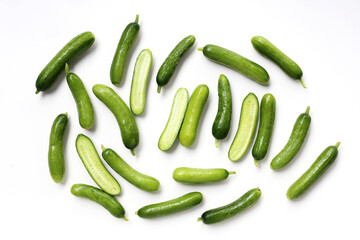 Fresh mini baby cucumbers on white background