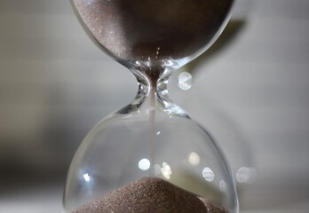 Hourglass as symbol of passing time concept photo shadow on the wall	