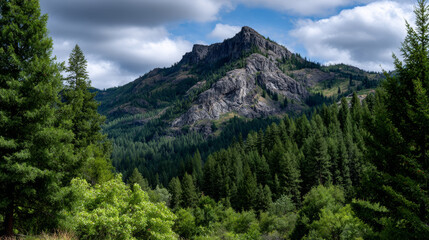 Majestic mountain rises proudly above lush green forest, creating breathtaking view, tranquil and serene natural landscape