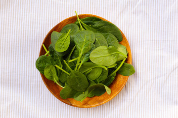 Spinach leaves on striped cloth.