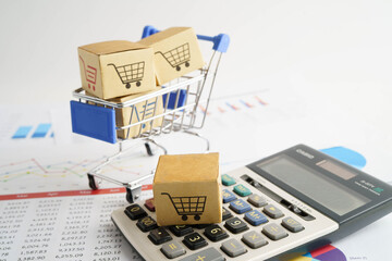 Online shopping, Shopping cart box on calculator, import export, finance commerce.