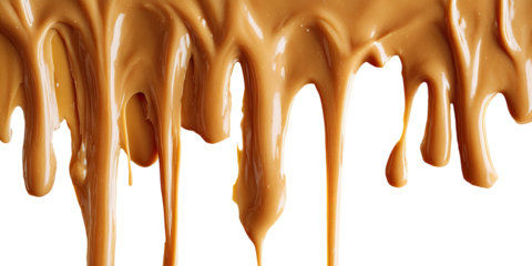 Drips of smooth, brown caramel flowing down over a black background