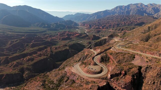 Aerial view of winding Cuesta de Miranda road through dramatic mountains in La Rioja Province, Argentina.