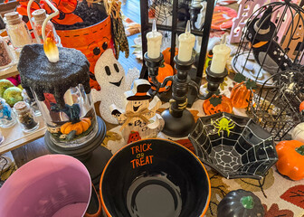 Playful Halloween Table Decorations. Assortment of Trick or Treat Bowl, Ghost Figurines, Spiderweb Dish, and Black Candlesticks for a Festive Home Display