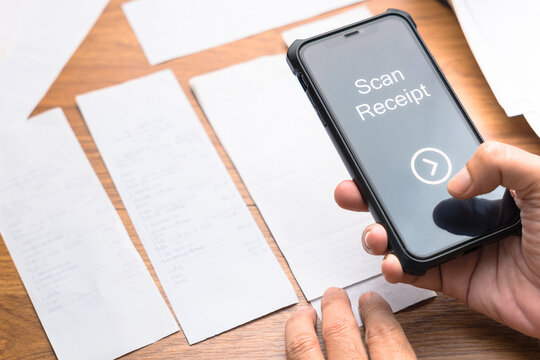 Hand using smartphone to scan and photograph receipts for budgeting, expense tracking, and tax deduction - Powered by Adobe