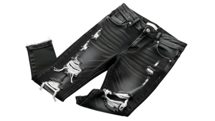 Frayed black denim trousers displaying distressed rips are isolated against a solid dark background