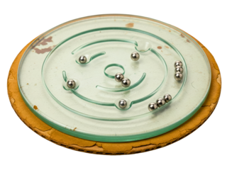 Vintage round glass labyrinth maze game with small metal balls on a transparent background