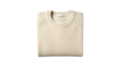 Cream colored knitted pullover garment folded neatly against a dark background