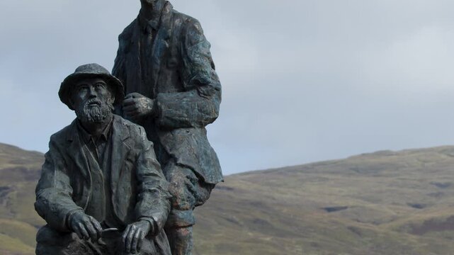 Bronze Highlander Monument Against Scottish Mountain Landscape