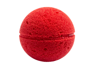 A vibrant, spherical, red object, bisected by a slight crevice, appears to hover against a stark black background. It has a textured, porous surface