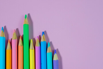 colored pencils on a pink background
