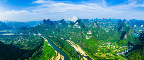 Aerial shot of the famous karst mountain landscape and winding river with lush green forest in Guilin