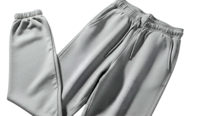 Casual gray athletic trousers with elastic cuffs and drawstring waist displayed against a dark backdrop