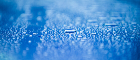 water drops on blue background, panoramic banner with copy space
