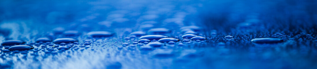 water drops on blue background, panoramic banner with copy space