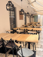 outdoor seating at a restaurant with table and chairs in a narrow street in Croatia