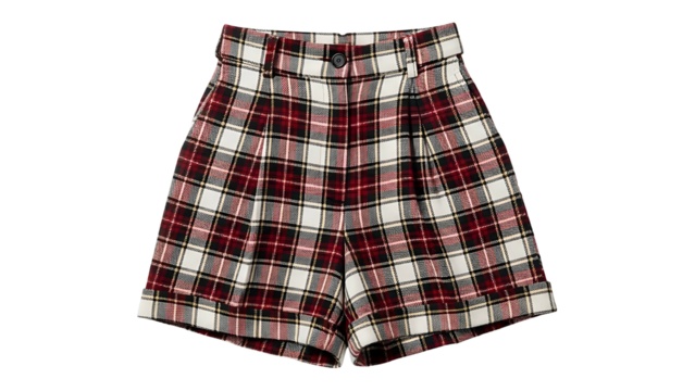 High waisted pleated woolen shorts display a prominent red white and black plaid pattern