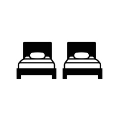 Two identical beds with pillows side by side