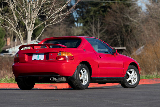 Portland, OR, USA-Jan 14, 2021-1995 red Honda Civic Del Sol DOHC VTEC Japanese two door two seater sport car parked outdoors, classic compact coupe ideal for automotive media and documentation