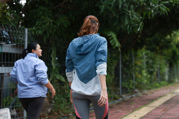 Slim and Plus size woman with sport jacket walk exercise outdoor, wellness lifestyle, wellness and healthy lifestyle