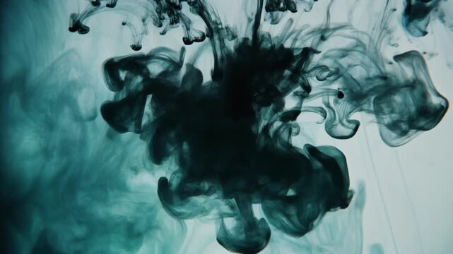 Abstract Ink Cloud: Mesmerizing Black and Teal Dye in Water.