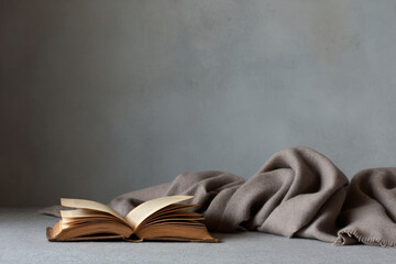 beautifully aged prayer book resting gently on soft woolen blanket creates minimalistic still life