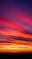 Vibrant twilight spectacle featuring intensely colored clouds stretching across a vast, fiery horizon line at dusk, Sunset, dramatic, beam