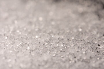 Close-up of the surface of white salt grains, macro salt