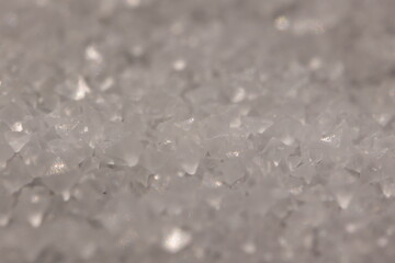 Close-up of the surface of white salt grains, macro salt